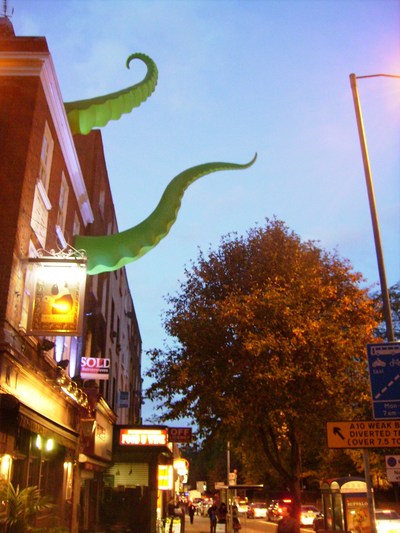 A building with inflatable tentacles coming out of the windows